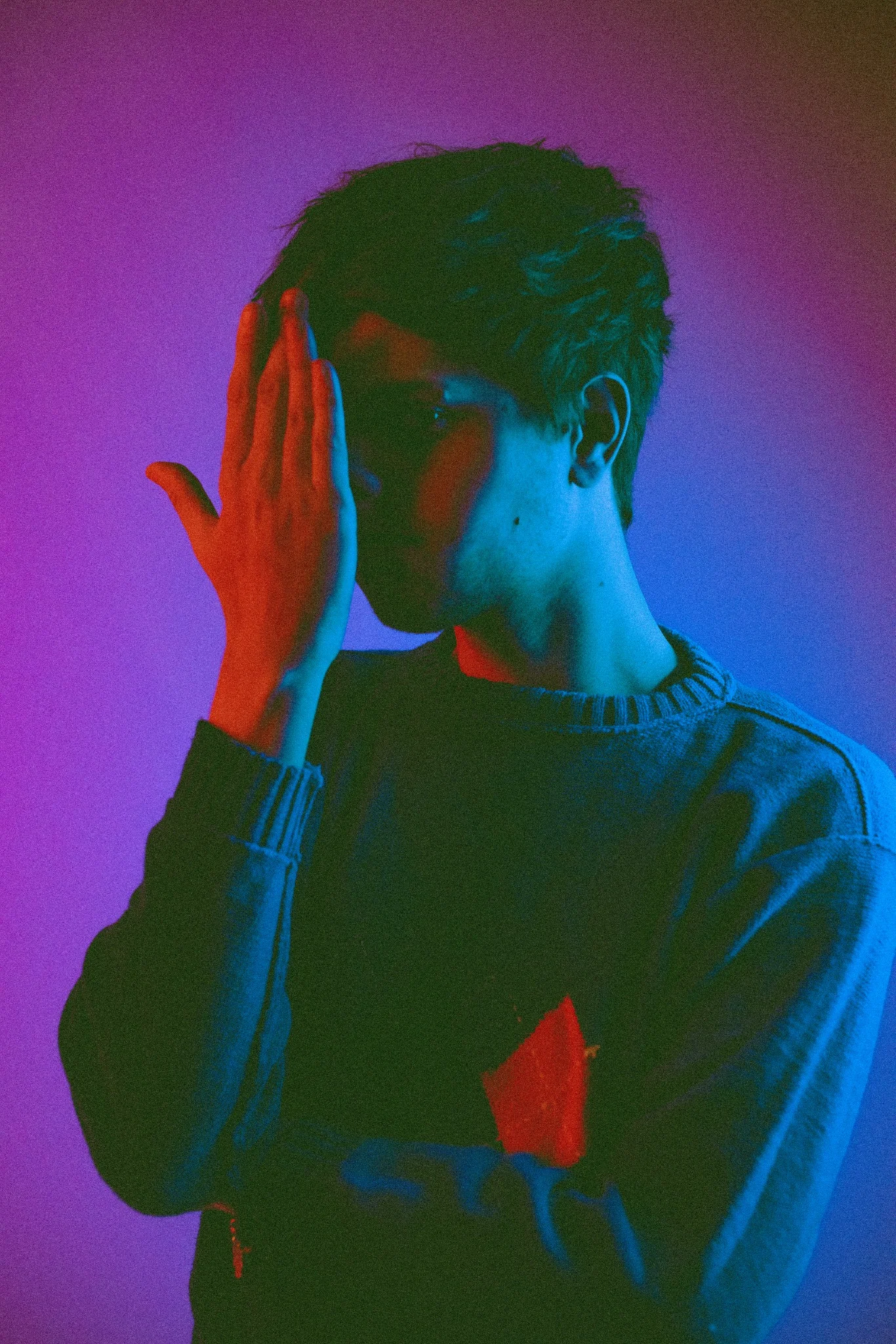Omri artist portrait lit in pink and blue